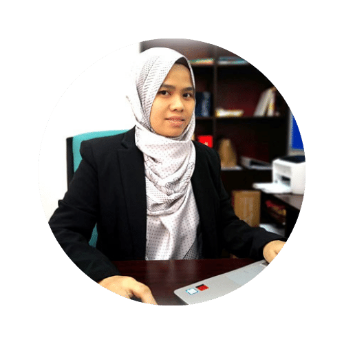 a picture of Dr Nurhafizah Mahri sitting in front of her laptop